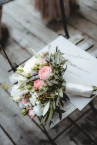 pink and white roses bouquet on white book page