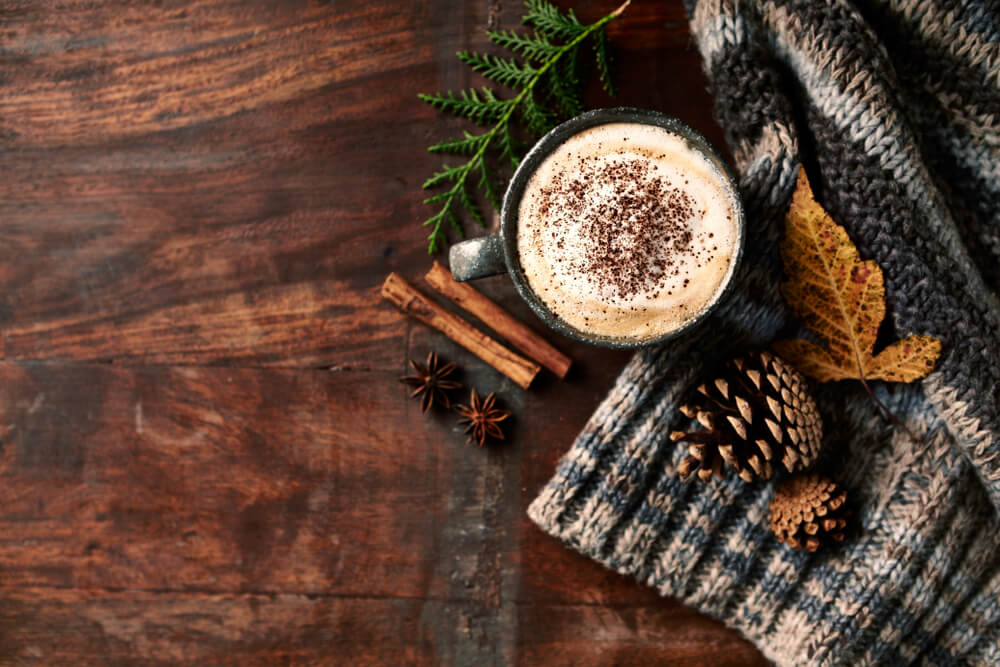 Cup of coffee with spices on autumn day