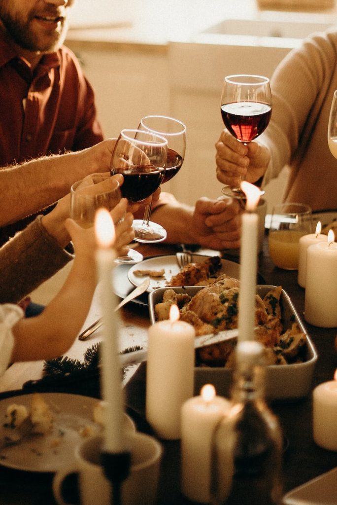 People Holding Wine Glasses. Thanksgiving Dinner